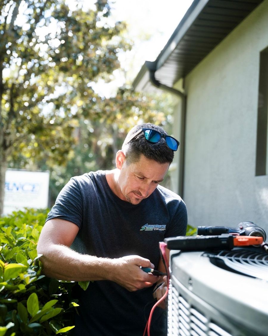 HVAC technician servicing a condenser unit