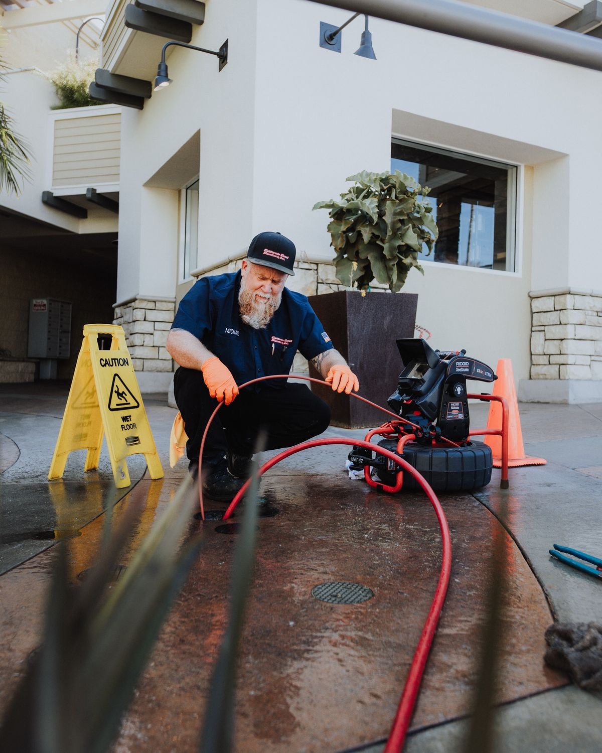 Plumber running a sewer camera inspection