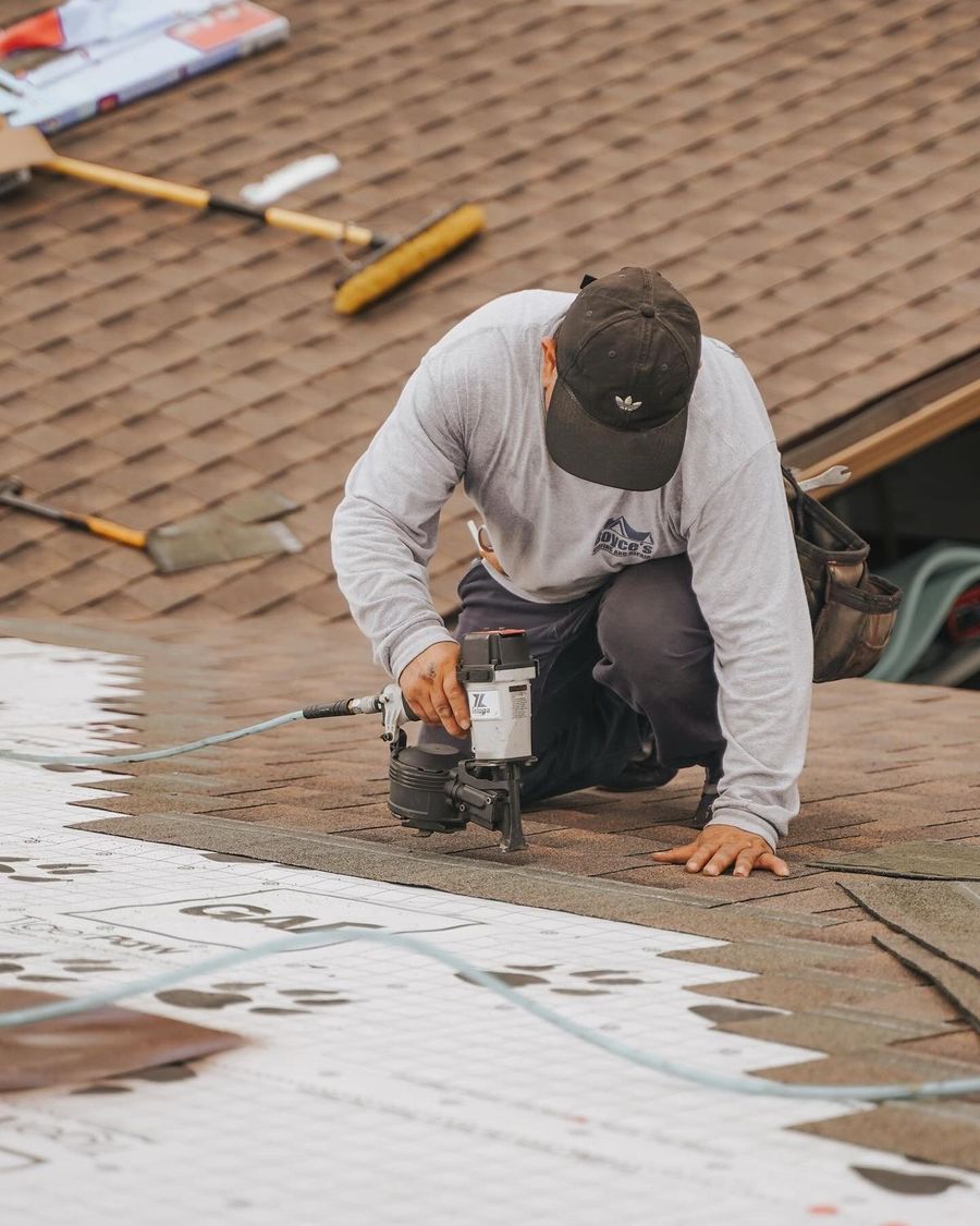 Roofer installing shingles